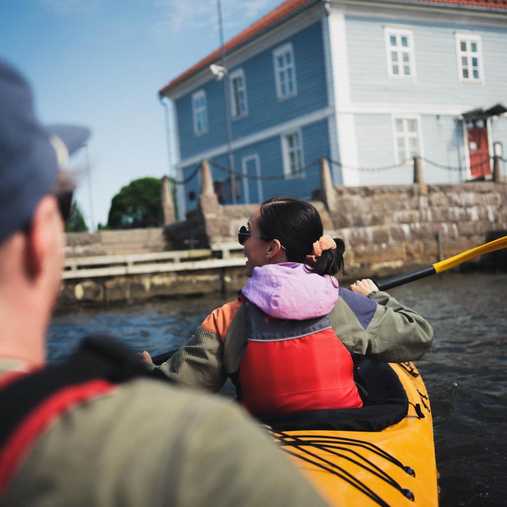 A couple paddling outside The Packhouse museum.